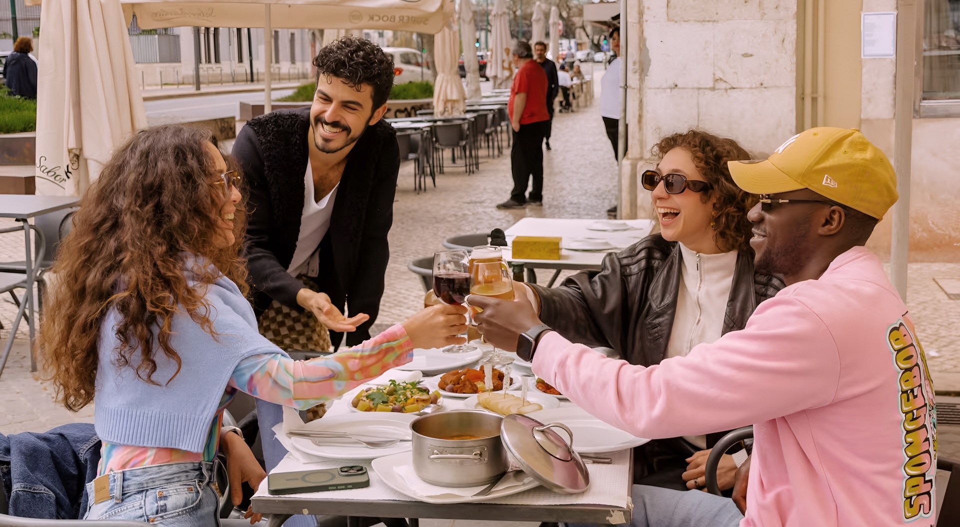 Friends toasting with wine on a Lisbon street